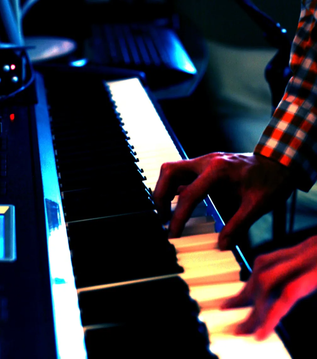 Color-treated close view of Ryan's hands performing on a keyboard