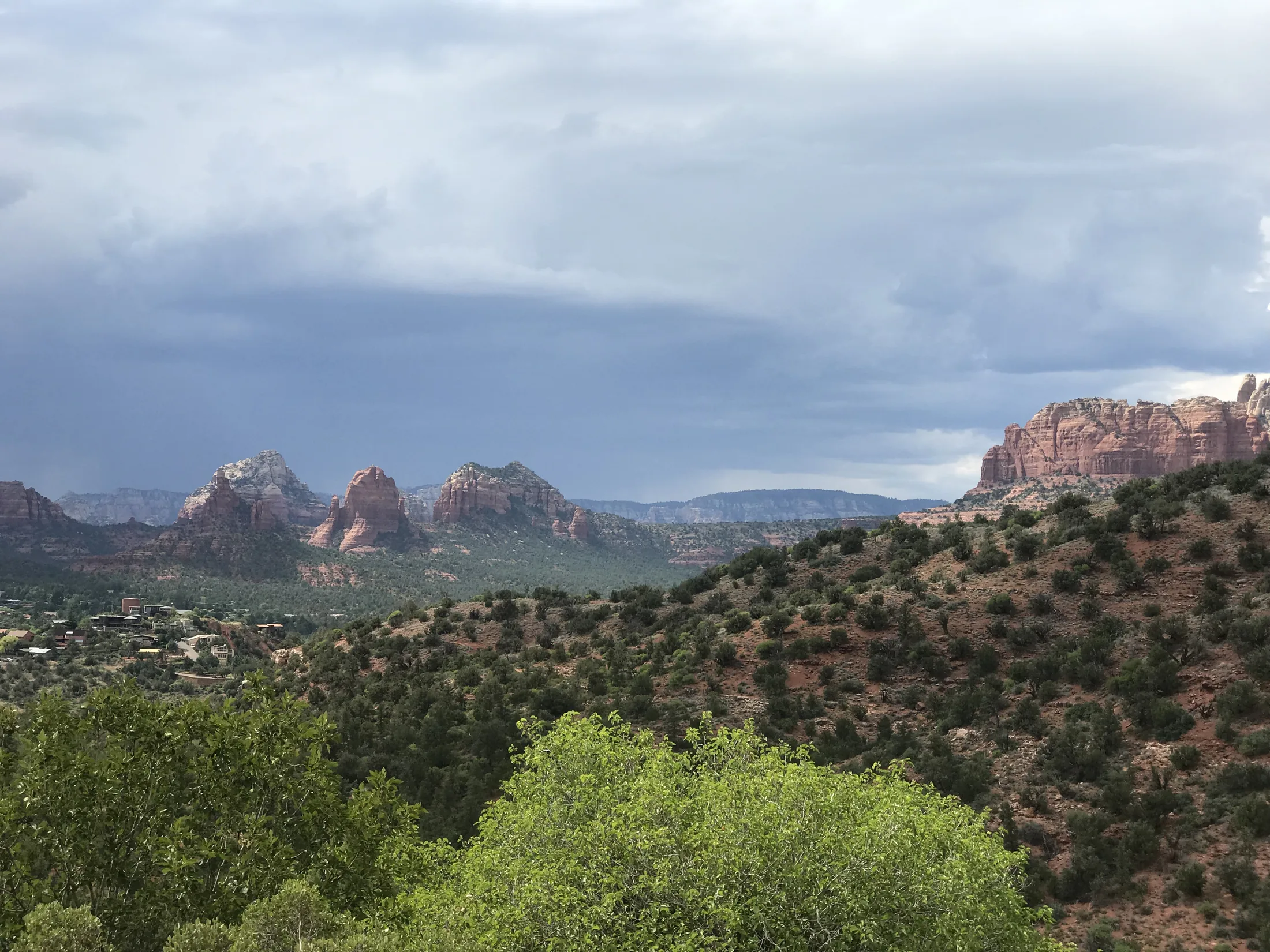 Wide Sedona valley beneath a dark approaching storm